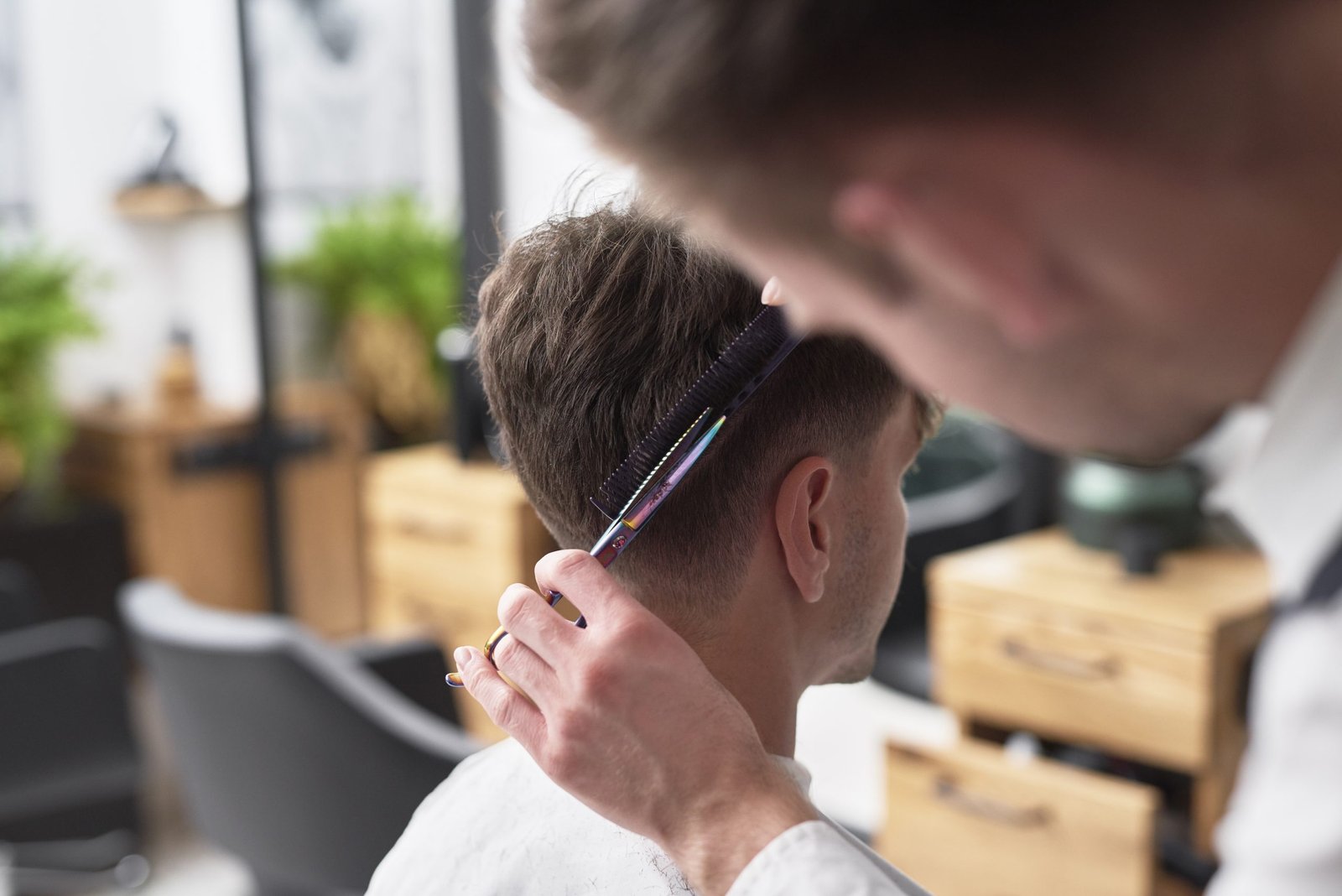 Young man has cutting hair at the hairdresser high-wycombe